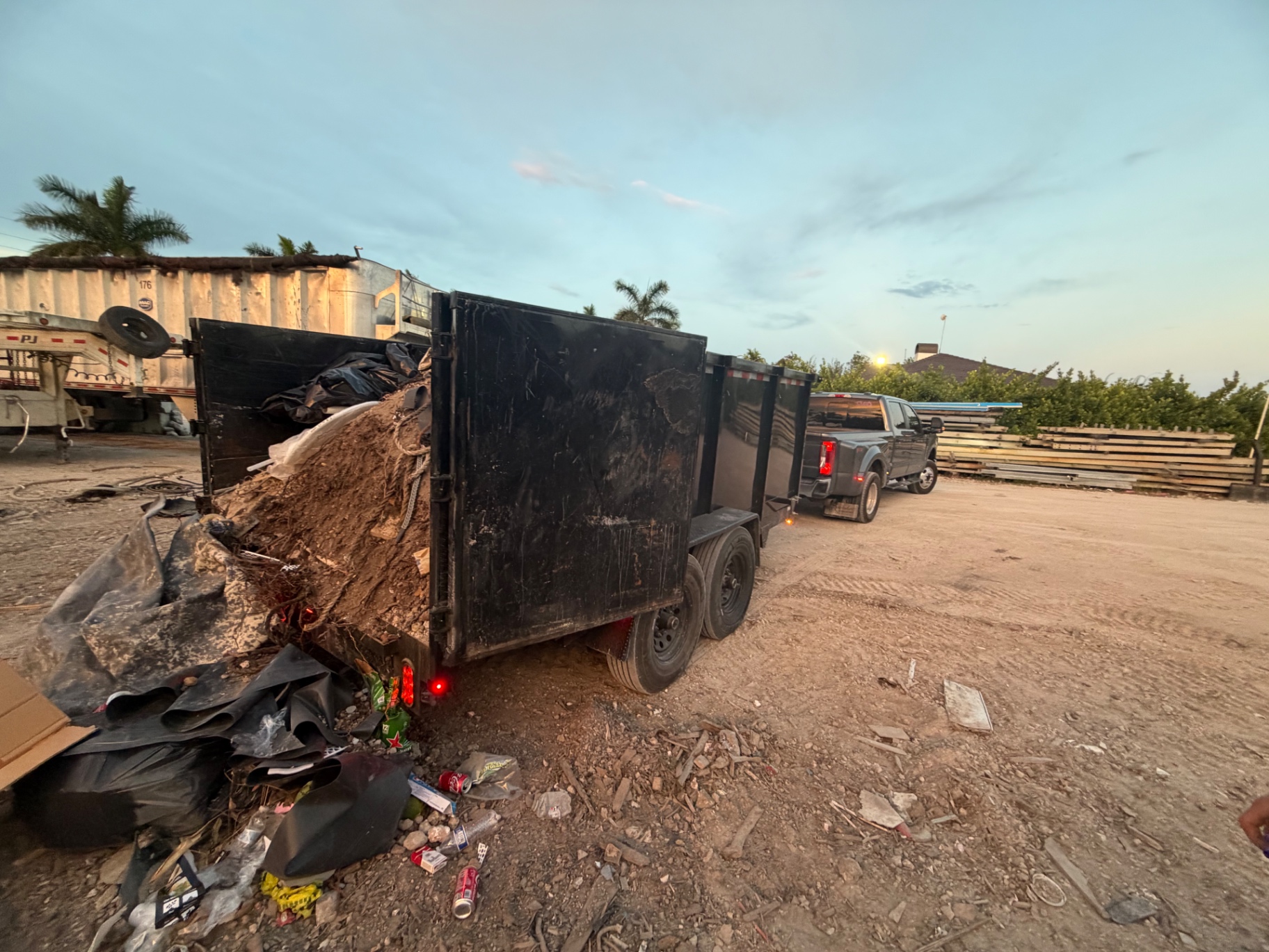 Loaded dump trailer with yard waste and debris